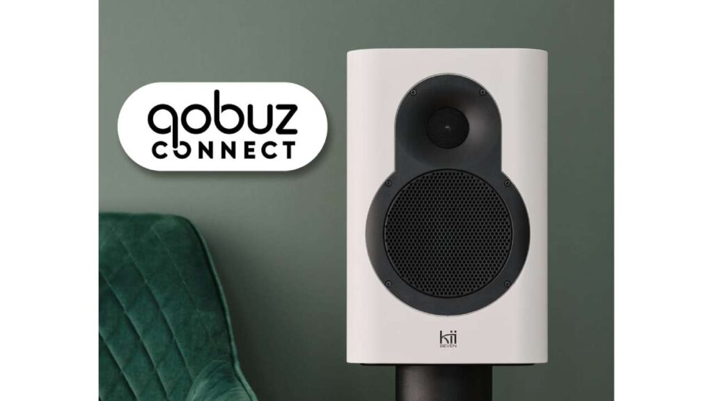 Close-up of a white Kii Seven speaker in front of a green background with the Qobuz Connect logo on the left.