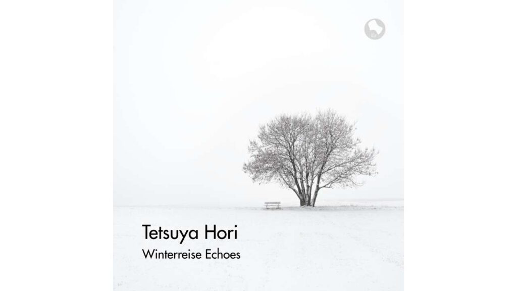 Album cover for “Winterreise Echoes” by Tetsuya Hori, showing a lone tree and bench in a minimalist snowy winter landscape.