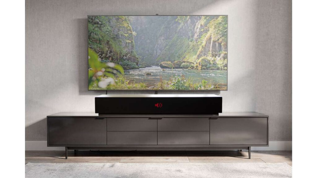 LIVEBOX soundbar beneath a television on a lowboard, with a landscape image above on a gray wall in the living room
