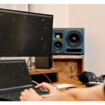 Laptop and screen showing HEDD CTRL software interface next to a blue HEDD studio monitor speaker.